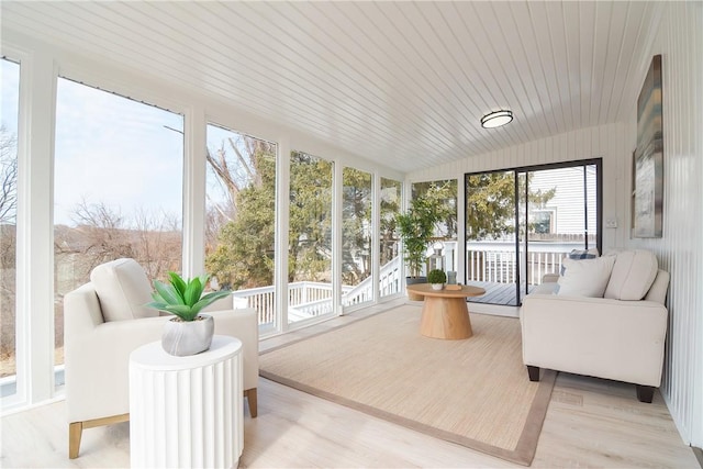 sunroom / solarium featuring wooden ceiling and vaulted ceiling