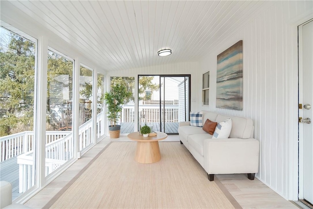 sunroom with vaulted ceiling and wood ceiling