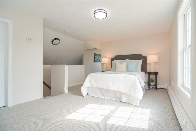 carpeted bedroom with lofted ceiling and baseboard heating