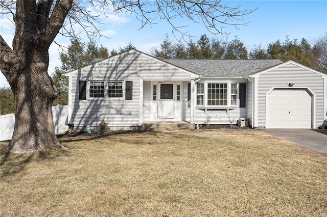 view of front of house with a front lawn, a garage, driveway, and a shingled roof