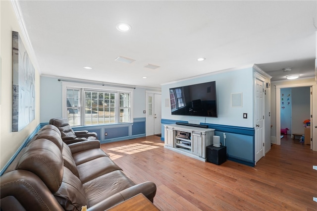 living area featuring crown molding, recessed lighting, and light wood-type flooring