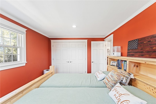 bedroom featuring a closet, baseboards, and ornamental molding