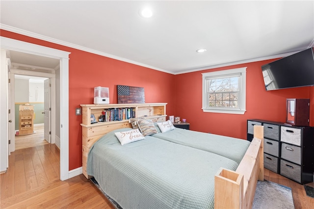 bedroom with crown molding, recessed lighting, wood finished floors, and baseboards