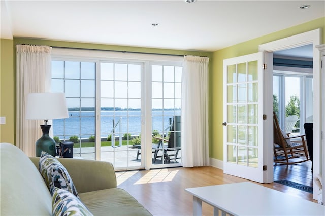 living room featuring wood finished floors and a water view