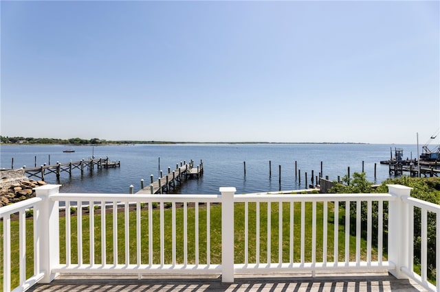 view of dock featuring a water view and a lawn