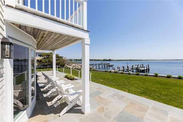 view of patio / terrace featuring a water view, a balcony, and a dock