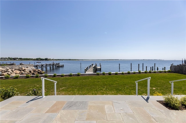 view of patio featuring a water view and a dock