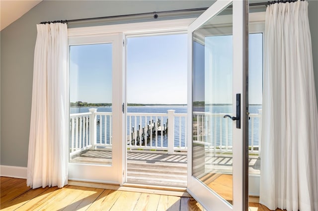 entryway featuring wood finished floors and a water view