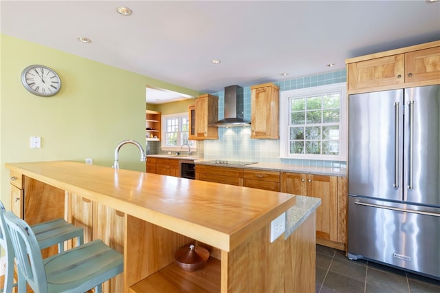 kitchen featuring tasteful backsplash, high quality fridge, wall chimney exhaust hood, and open shelves