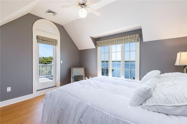 bedroom with access to exterior, visible vents, light wood-type flooring, lofted ceiling, and multiple windows