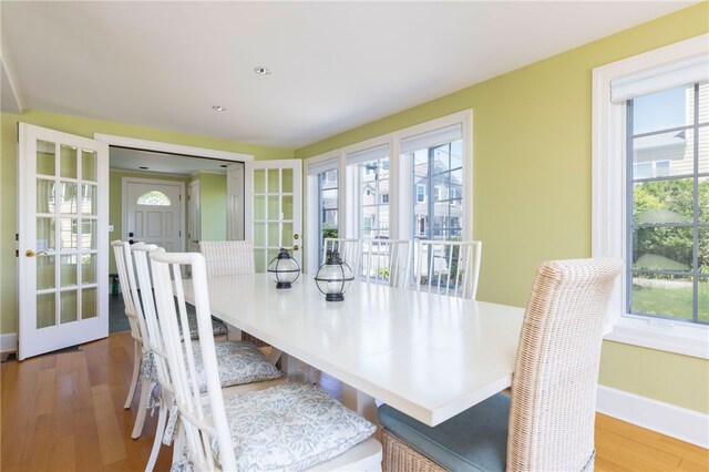 dining room with baseboards and wood finished floors