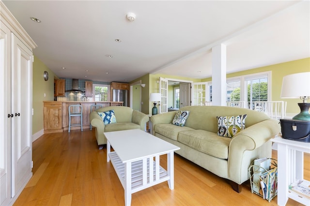 living area featuring light wood finished floors and recessed lighting