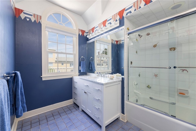 bathroom featuring tile patterned floors, vanity, enclosed tub / shower combo, and baseboards