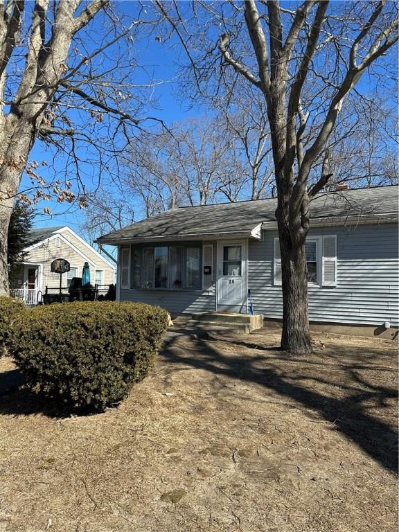 view of front of home with a shingled roof