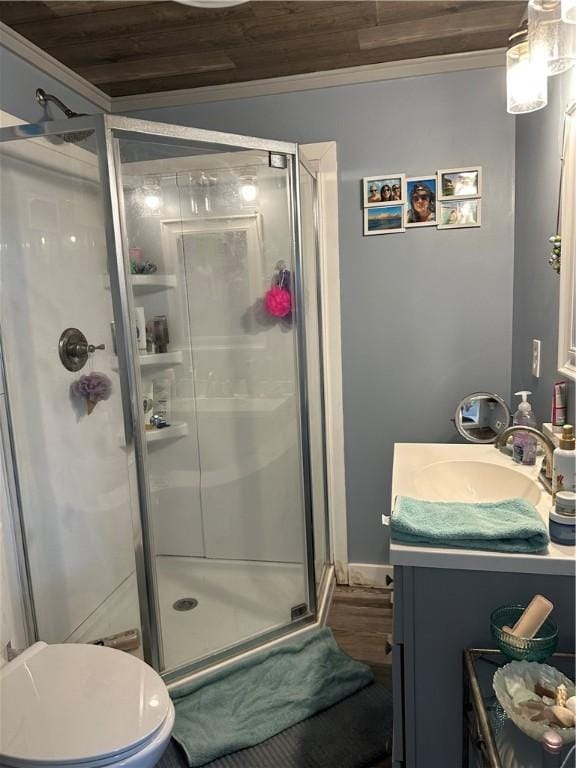 bathroom with toilet, wood finished floors, wooden ceiling, a shower stall, and vanity