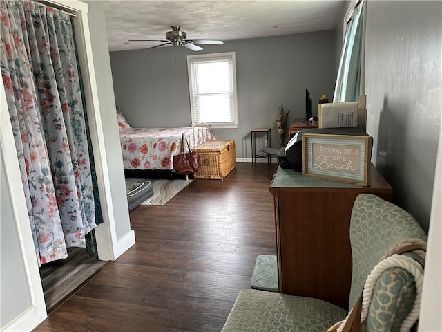bedroom featuring baseboards, a ceiling fan, and wood finished floors