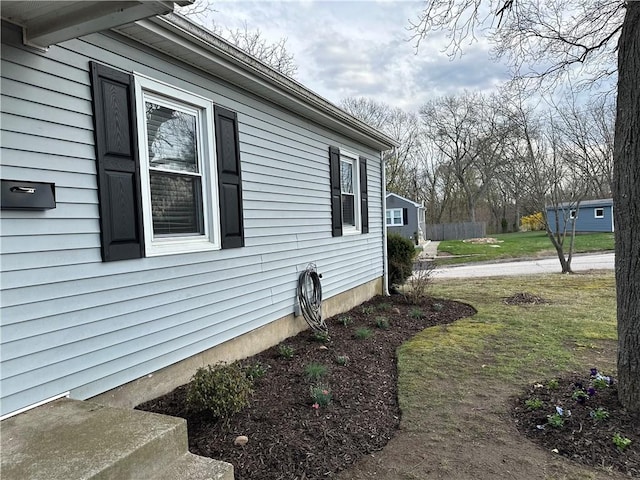 view of side of home with a lawn