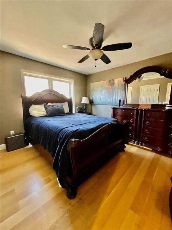 bedroom with light wood-type flooring and a ceiling fan