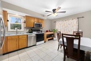 500 Kingstown Rd Unit 3B, Richmond, RI 02892 - kitchen featuring stainless steel appliances, brown cabinets, a sink, and light countertops
