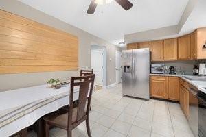 500 Kingstown Rd Unit 3B, Richmond, RI 02892 - kitchen with stainless steel fridge, ceiling fan, brown cabinetry, and light countertops