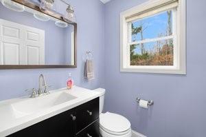 500 Kingstown Rd Unit 3B, Richmond, RI 02892 - half bath featuring vanity, toilet, and baseboards