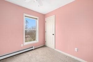 500 Kingstown Rd Unit 3B, Richmond, RI 02892 - spare room with a baseboard heating unit, a ceiling fan, light colored carpet, and baseboards