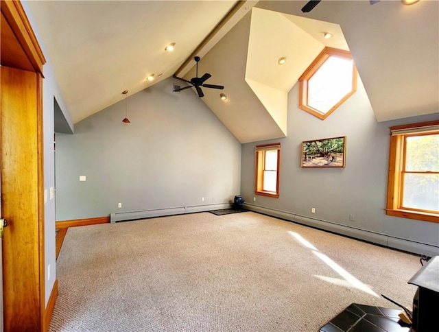 additional living space with beam ceiling, carpet floors, a wealth of natural light, and ceiling fan