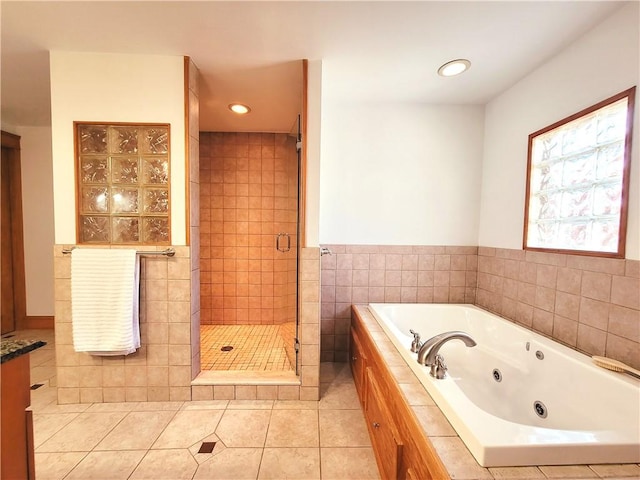 full bath with tile patterned flooring, a tub with jets, recessed lighting, and a stall shower