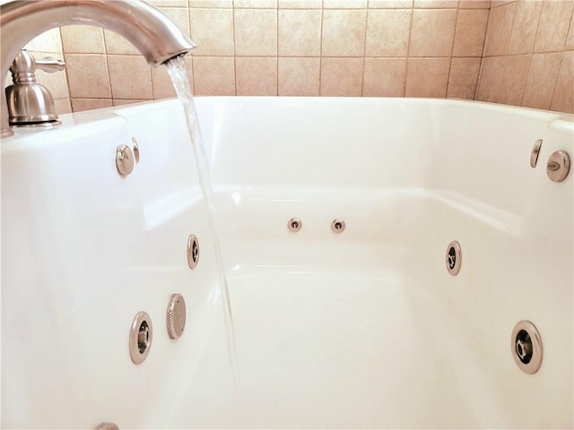 full bathroom featuring a tub with jets