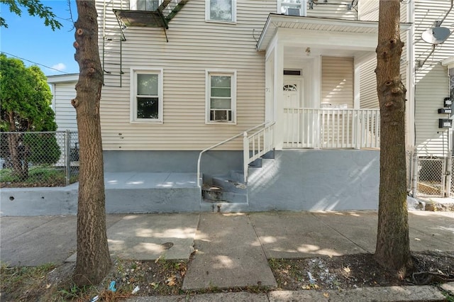 view of exterior entry with fence