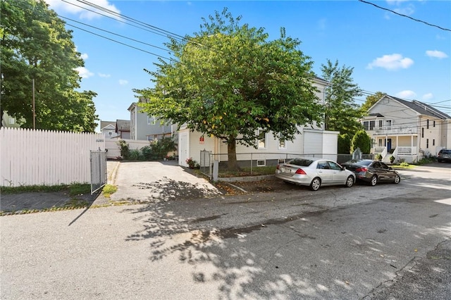 obstructed view of property with a residential view and fence