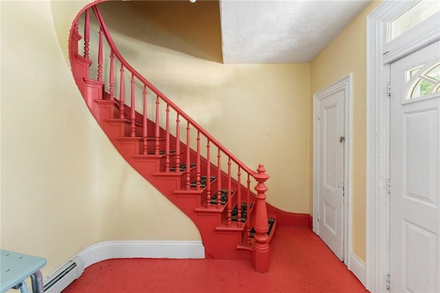 staircase featuring baseboards and carpet flooring