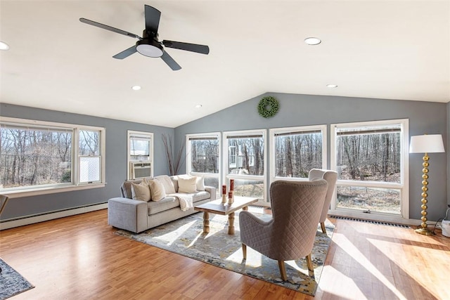 living area with vaulted ceiling, baseboard heating, recessed lighting, wood finished floors, and a ceiling fan