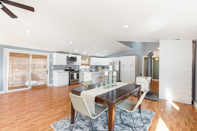 dining space featuring lofted ceiling, recessed lighting, a ceiling fan, and light wood-style floors