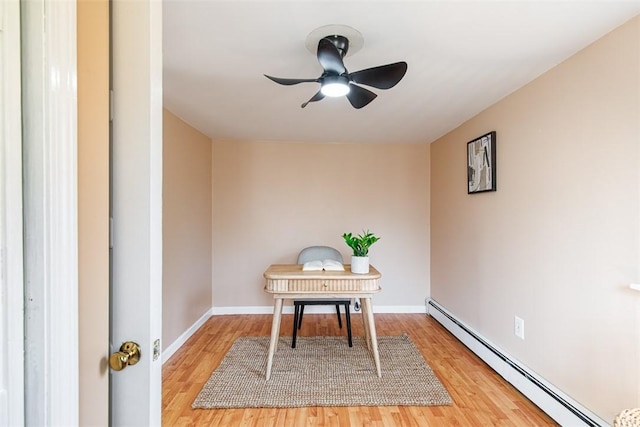 office featuring light wood-style flooring, baseboards, a baseboard heating unit, and ceiling fan