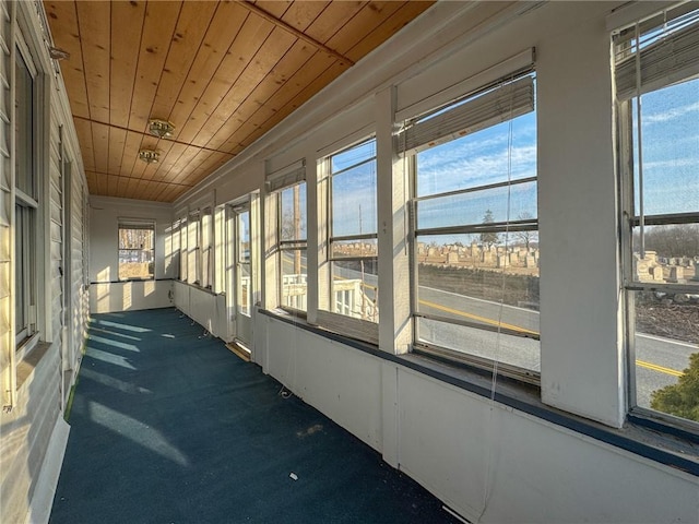 unfurnished sunroom with wooden ceiling