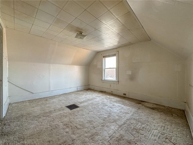 bonus room featuring visible vents, lofted ceiling, and carpet floors