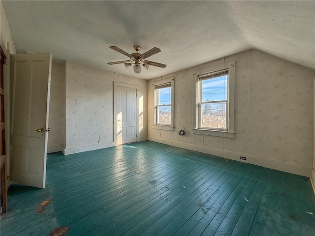 additional living space with lofted ceiling, a ceiling fan, dark wood-style flooring, and baseboards