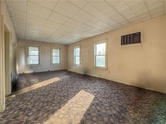 carpeted spare room featuring baseboards