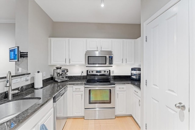 kitchen featuring a sink, white cabinetry, and stainless steel appliances