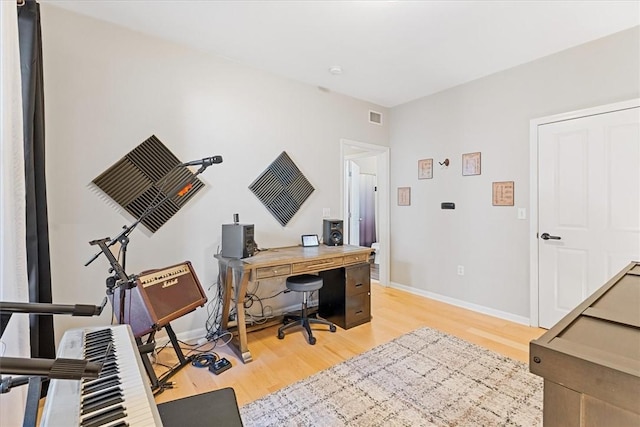 home office featuring visible vents, baseboards, and light wood-style flooring