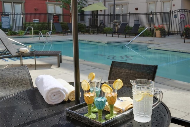 pool featuring a patio and fence