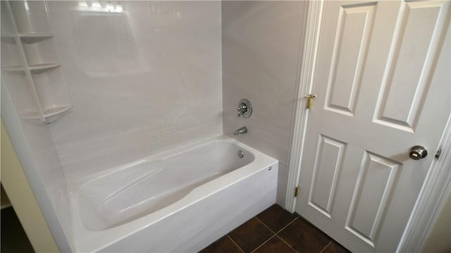 bathroom with tile patterned flooring, a bathtub, and a shower