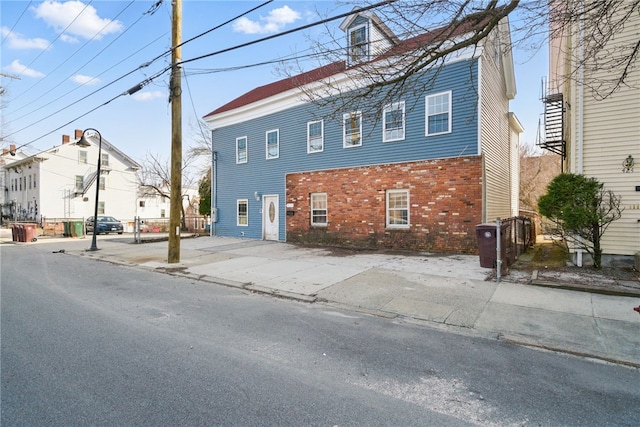 rear view of property with brick siding