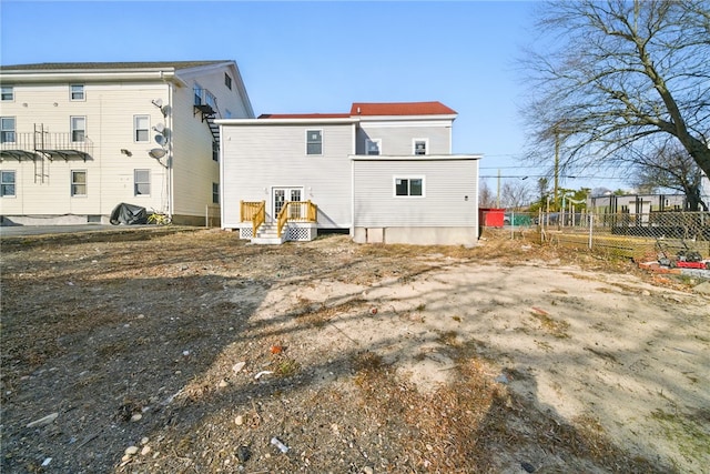 back of property featuring fence