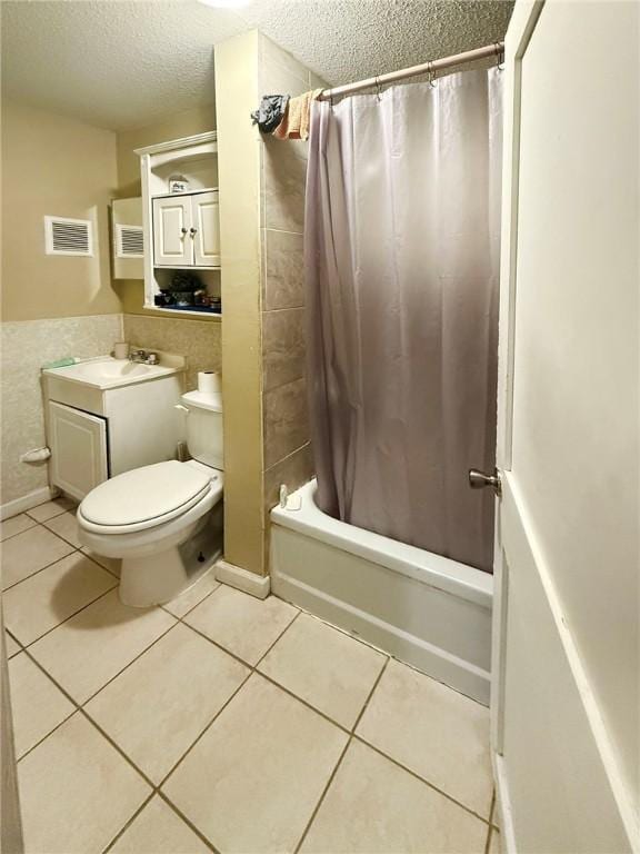 full bath with tile patterned flooring, visible vents, toilet, vanity, and a textured ceiling