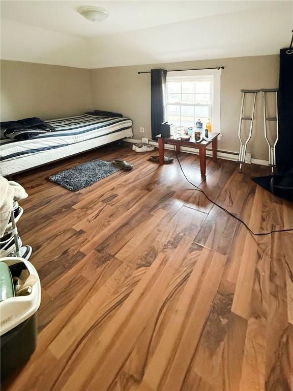 bedroom with wood finished floors and baseboards