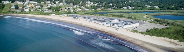 birds eye view of property with a view of the beach and a water view