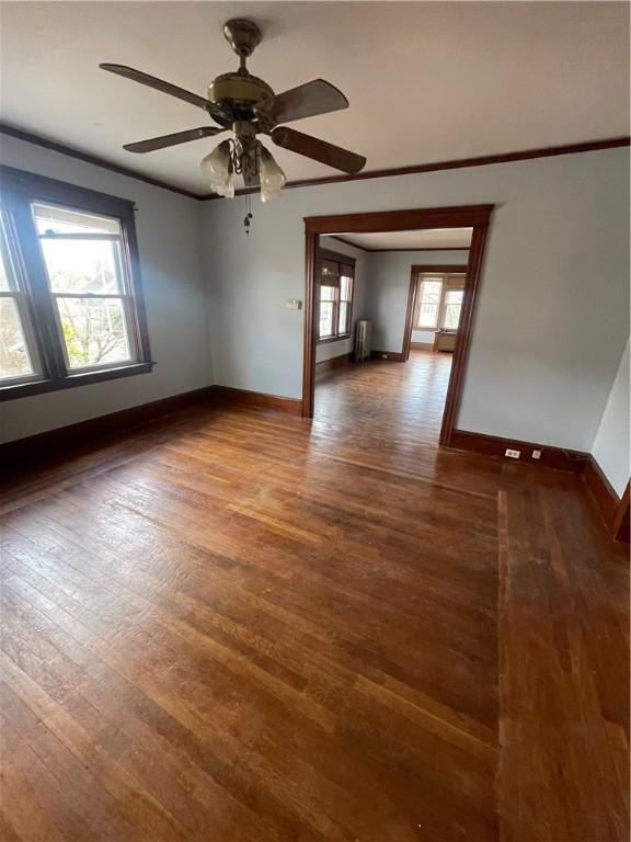 51 Oakland Ave, Cranston, RI 02910 - unfurnished room with radiator heating unit, baseboards, a ceiling fan, and wood finished floors
