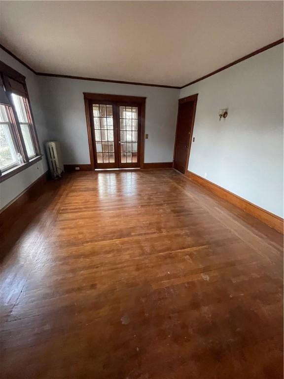 51 Oakland Ave, Cranston, RI 02910 - unfurnished room with baseboards, ornamental molding, radiator heating unit, and plenty of natural light